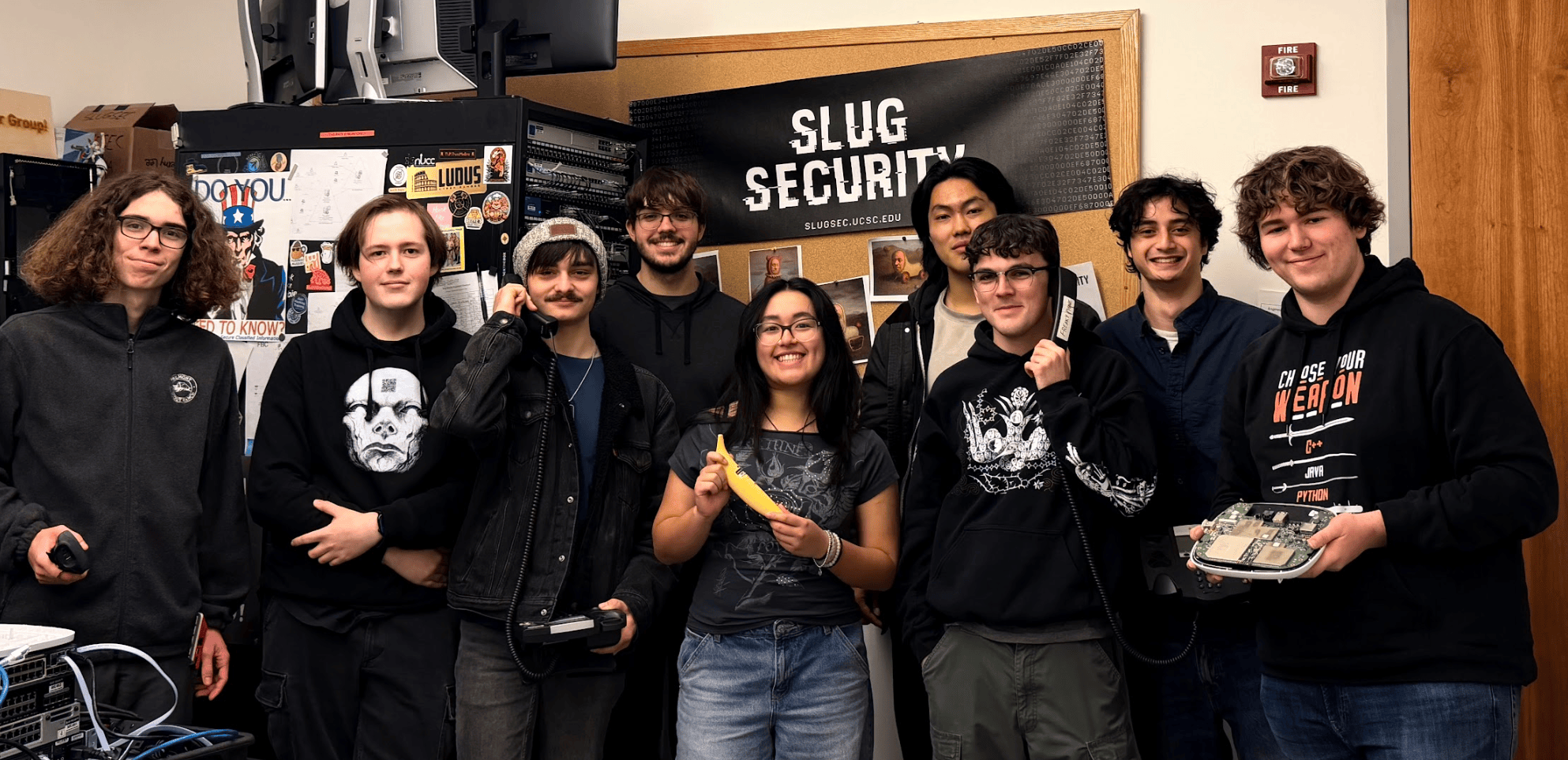 Student members of the Slug Security team posing with phones and a banana